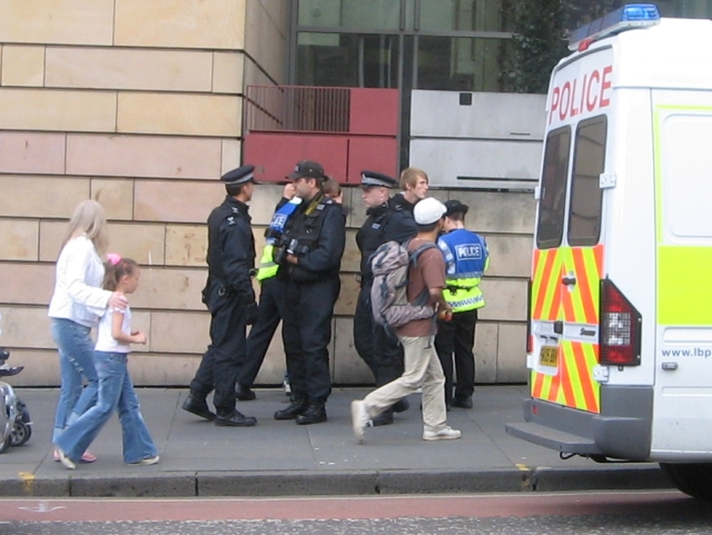 Members of demo being searched round the corner as they leave