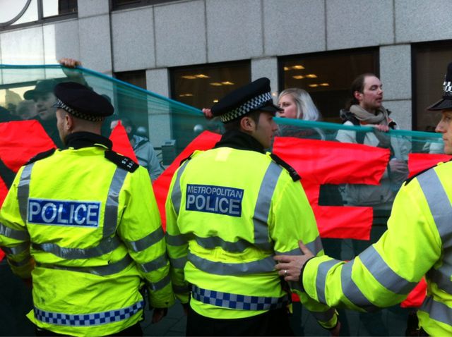 Cops try to force banner onto pavements